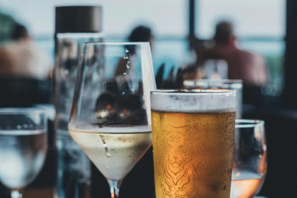 A glass of wine and a glass of beer on a table