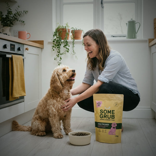 A cockapoo and its owner in a bright kitchen with a bowl of Some Grub and the 1.5kg bag
